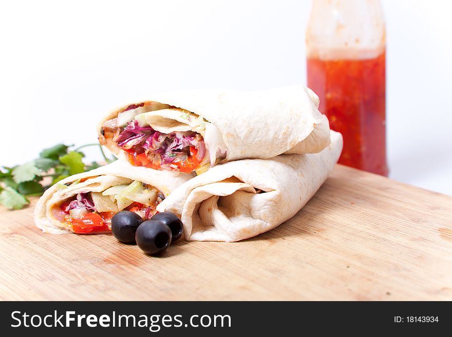 Tortilla with black olives on the chopping board