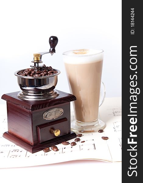 Coffee grinder and coffee on sheet music