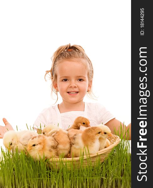 Happy spring girl with a basketful of little easter chicks in the grass - isolated