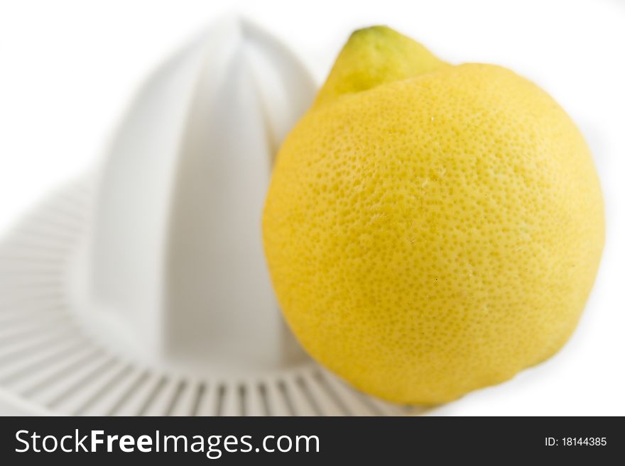 Lemon and juicer isolated on white background