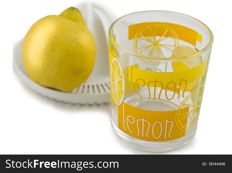 Lemon and juicer isolated on white background