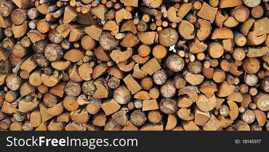 Logs of firewood in a nice stack, all piled up together.