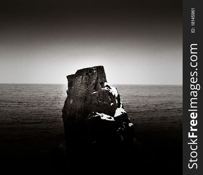 Lonely rock on cold swedish coast.