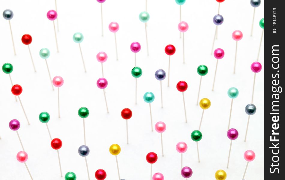 Colorful pins on a white background