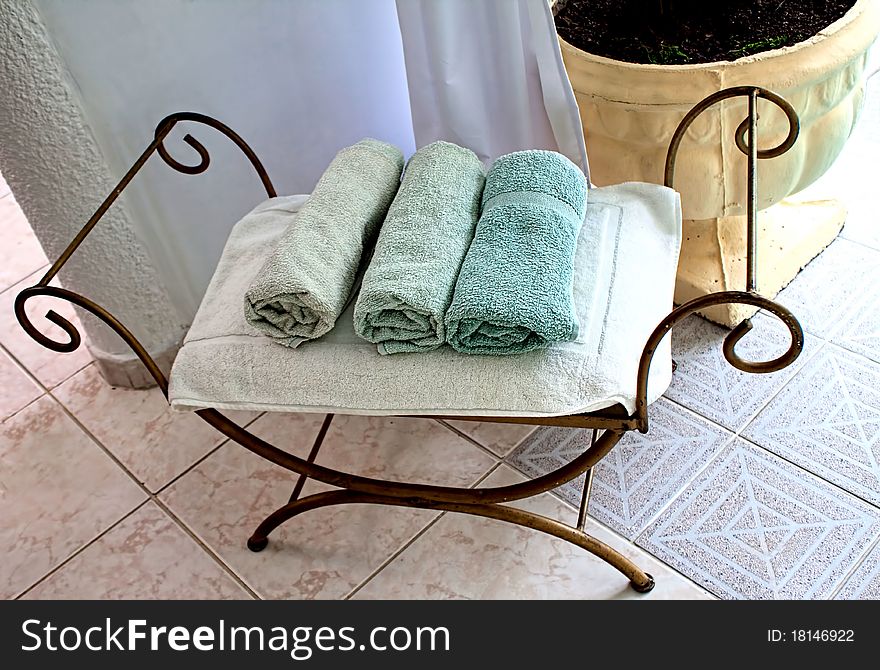 Luxury spa towels on metal stool