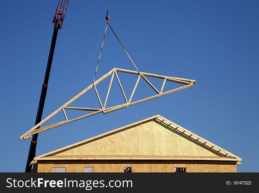 Crane lifting a roof onto a townhome. Crane lifting a roof onto a townhome