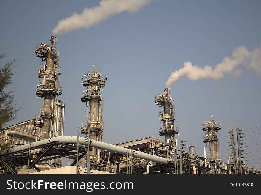 Set of industrial smokestacks with billowing white smoke. Set of industrial smokestacks with billowing white smoke.