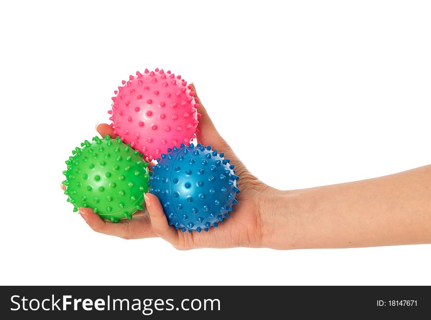Mother stretches three colored massage balls for the children's hands development to her baby