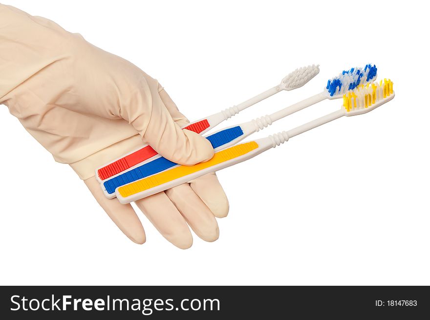 Red brush for toothpaste in the doctor's hand. Red brush for toothpaste in the doctor's hand