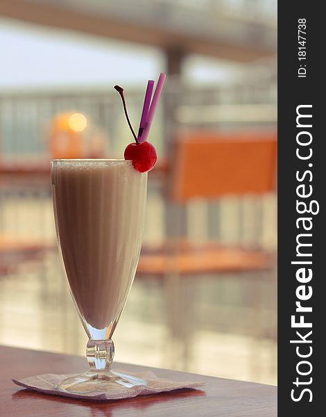 Milkshake with cherry and straw