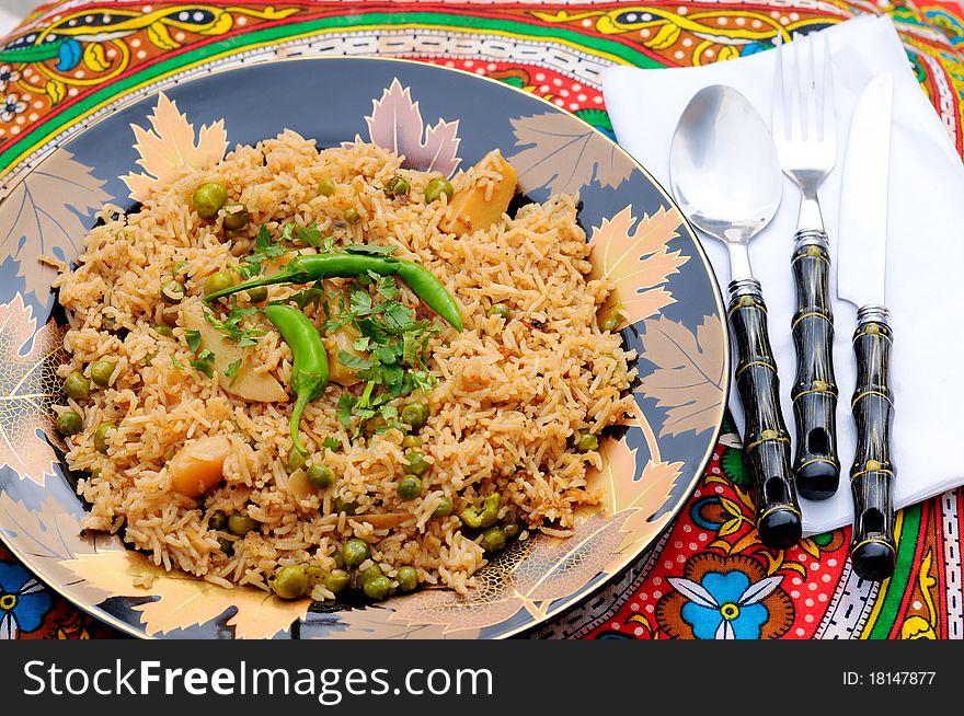 South Asian Traditional brown rice cooked with Potato, green peas, green chilies and tomatoes. South Asian Traditional brown rice cooked with Potato, green peas, green chilies and tomatoes.