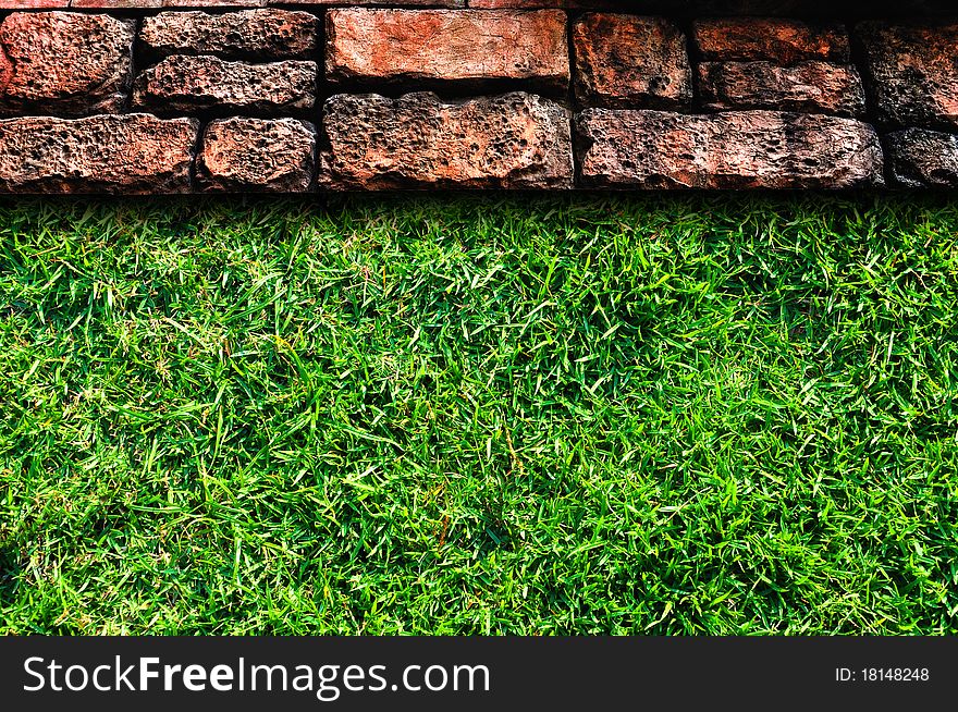 Old stone pavement and green grass field. Old stone pavement and green grass field