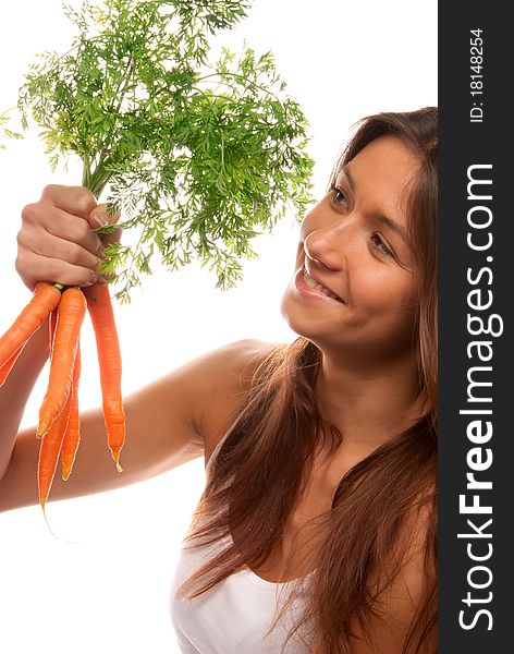 Young brunette healthy woman holding in right hand bunch fresh orange organic carrots with green leaves from the garden isolated on a white background. Young brunette healthy woman holding in right hand bunch fresh orange organic carrots with green leaves from the garden isolated on a white background