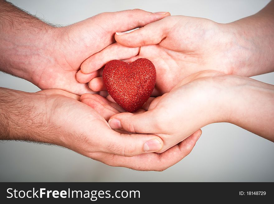 Man and woman hold red heart. Man and woman hold red heart