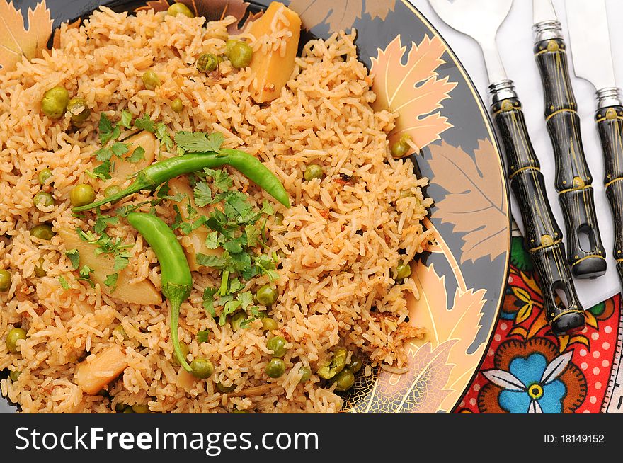 South Asian Traditional brown rice cooked with Potato, green peas, green chilies and tomatoes. South Asian Traditional brown rice cooked with Potato, green peas, green chilies and tomatoes.