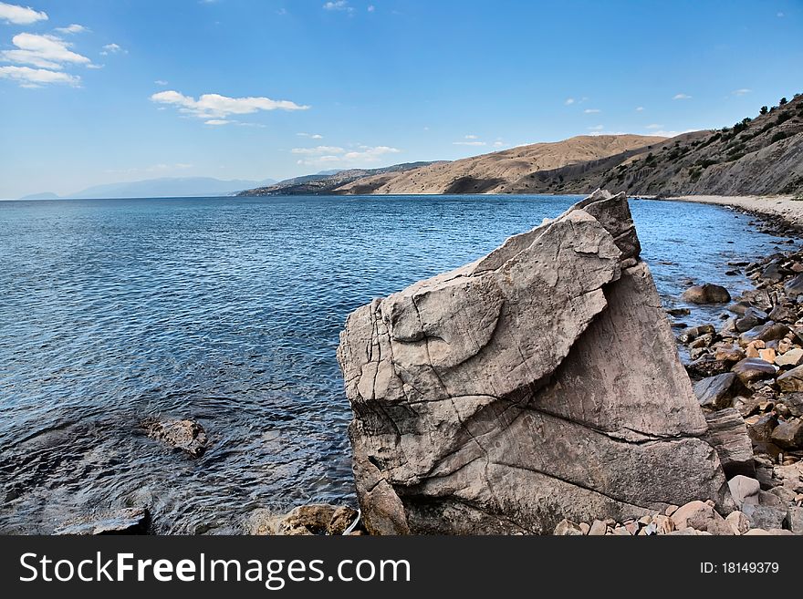 Stony seashore in the summer day