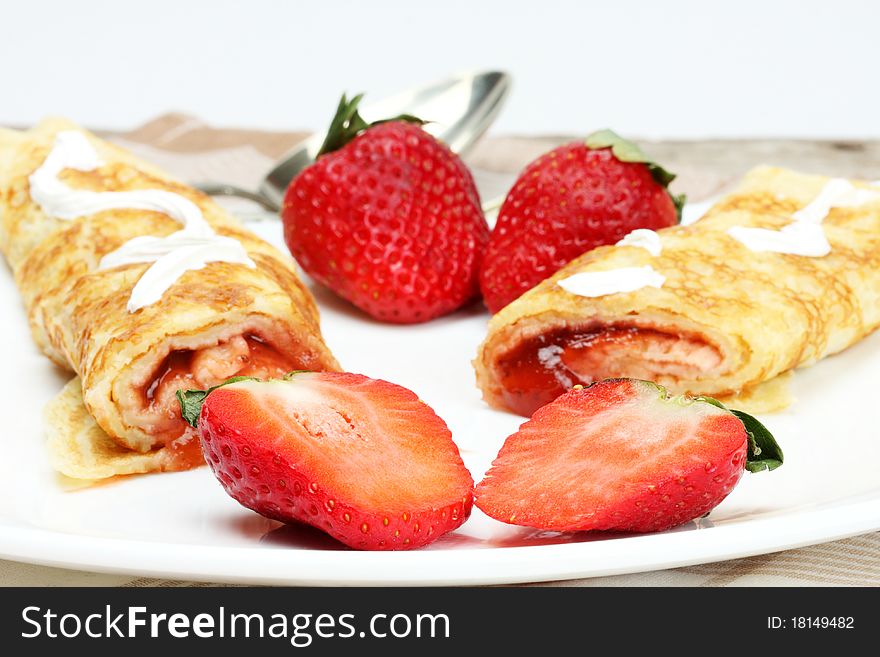 Pancakes with cream and strawberry