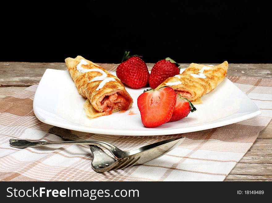 Pancakes with cream and strawberry