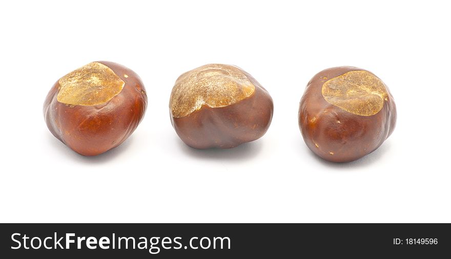 Three chestnuts isolated on white