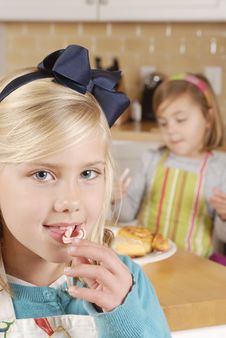 Young Girl With Candy Cane And Sister In Background Stock Photos Young Girl With Candy Cane And Sister In Background Stock Photos
