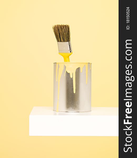 Paintcan and Paintbrush with spill on yellow background. Paintcan and Paintbrush with spill on yellow background