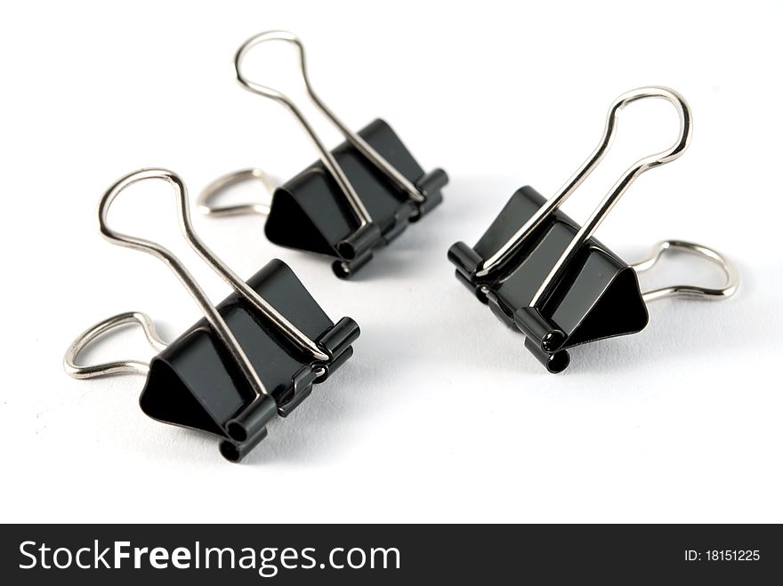 Three black clip on a white background isolated