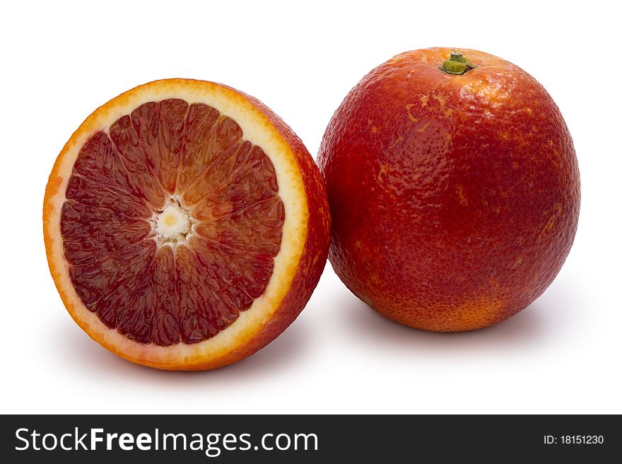 Red moroccan oranges, whole and half, isolated on white.