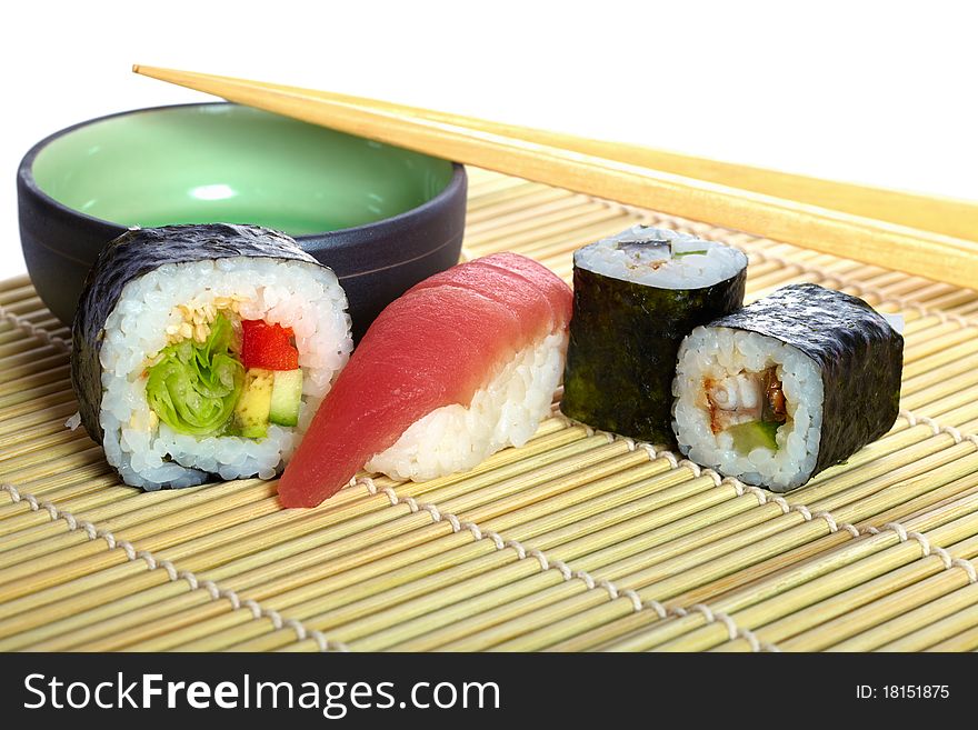 Studio photo of japanese mix sushi and rolls maki with plate and chopstick