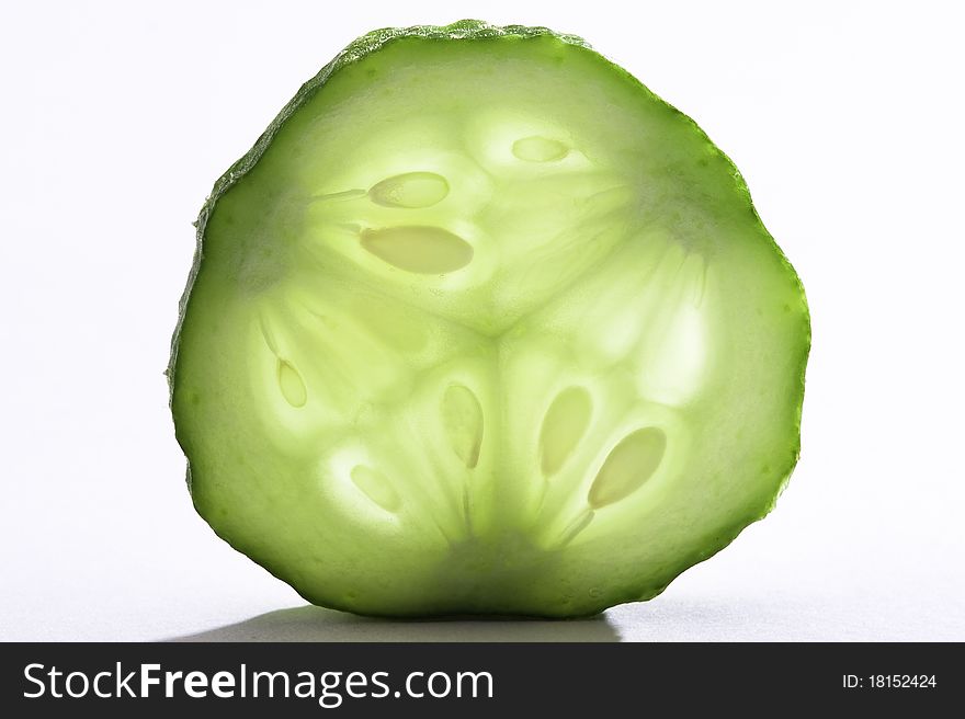 Single slice of fresh cucumber on white background. Single slice of fresh cucumber on white background