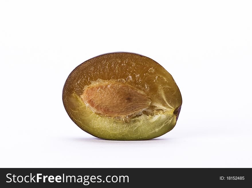 Halved plum on white background