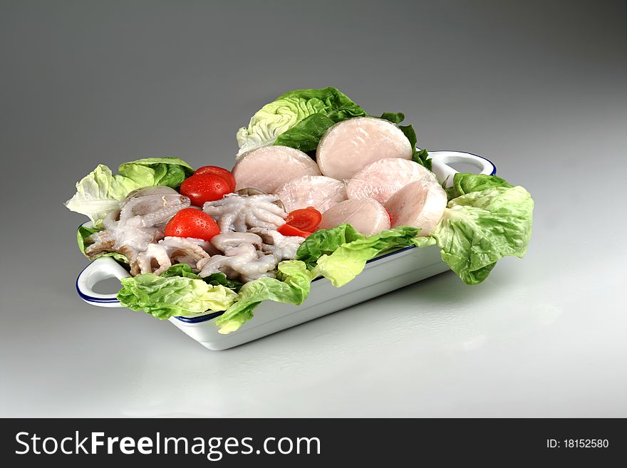 Tray with decorated salad of octopus, shellfish and lettuce. Tray with decorated salad of octopus, shellfish and lettuce