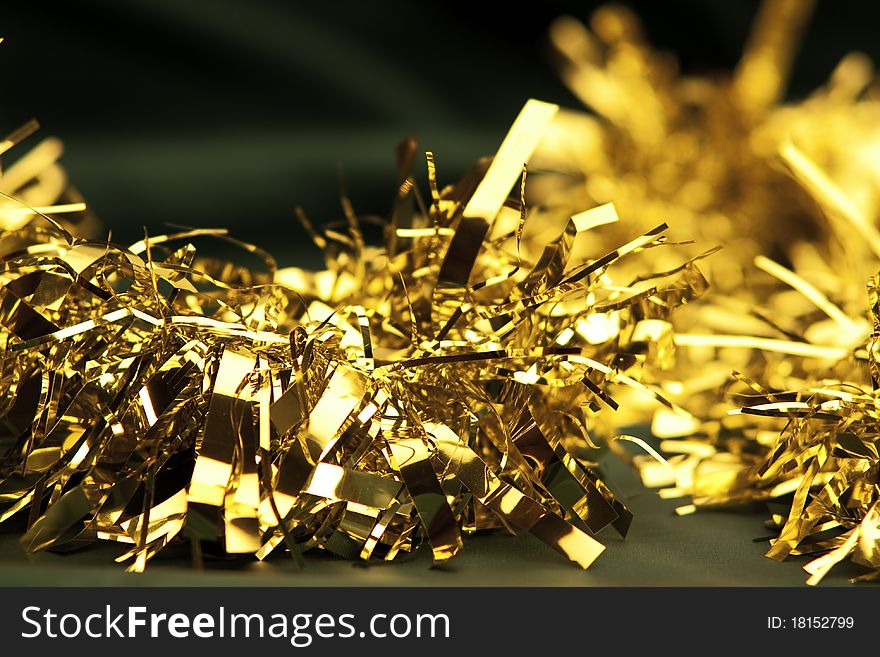 Golden christmas chain on green satin background