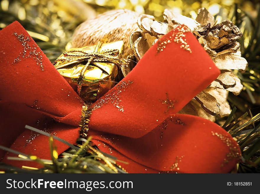 Close up of big red bow with golden christmas decoration. Close up of big red bow with golden christmas decoration.