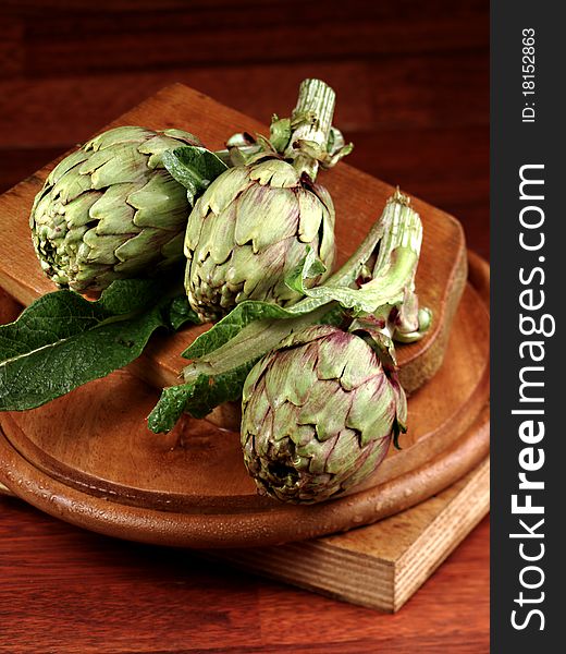 Rustic artichoke on the wood for breakfast. Rustic artichoke on the wood for breakfast