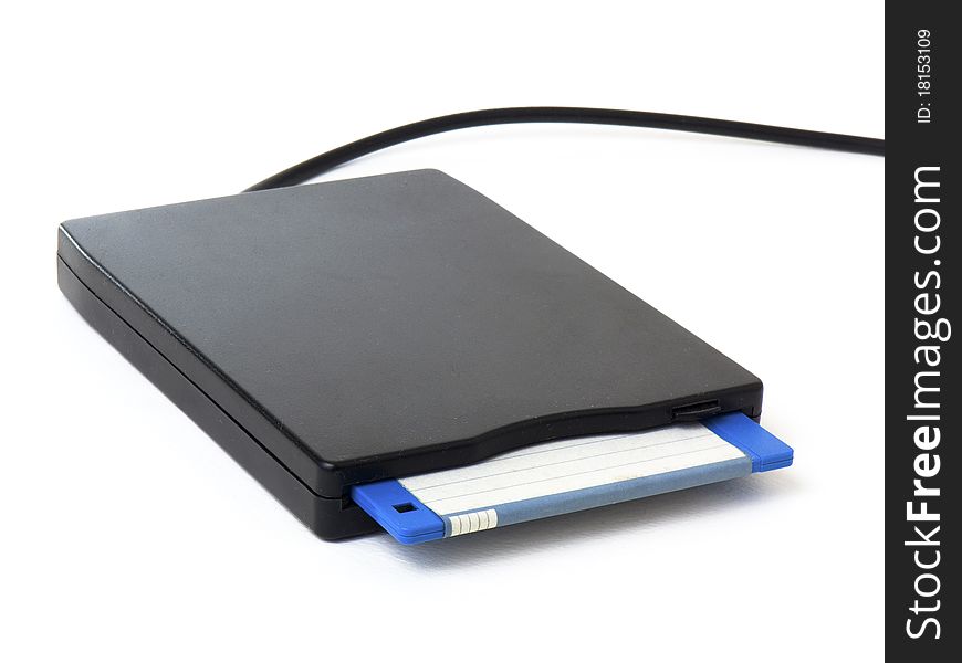 A black external usb floppy disk drive with a blue disk inside, isolated on white background. A black external usb floppy disk drive with a blue disk inside, isolated on white background