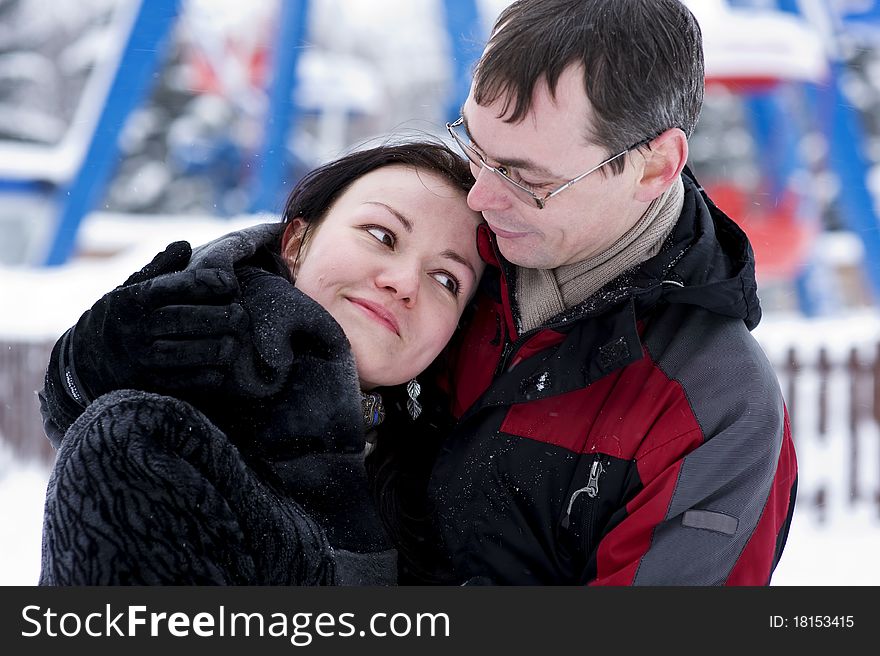 Happy couple hugging in winter time