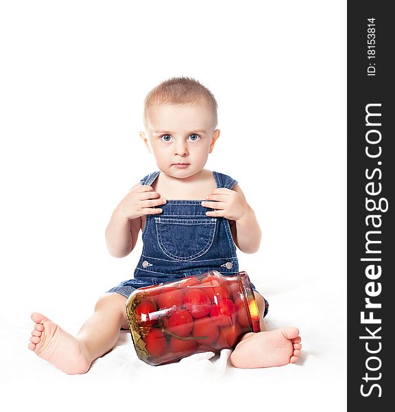 Small beautiful baby boy with tin of tomatoes on a white background