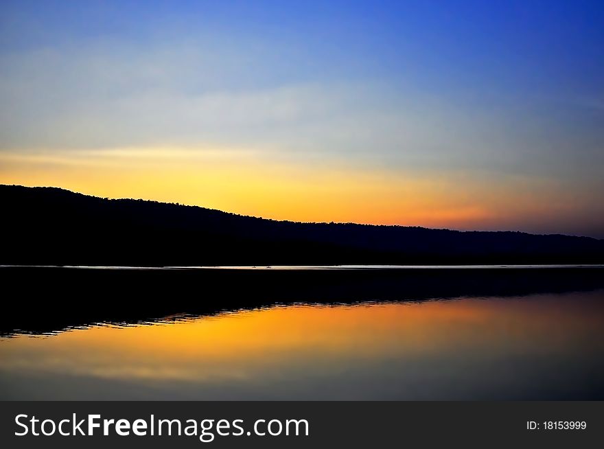 Beautiful sunset along the dam reflect on water surface