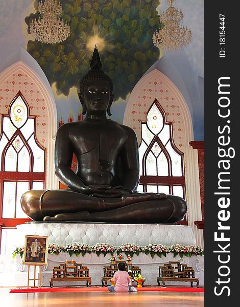 A woman worships image of Buddha. A woman worships image of Buddha.