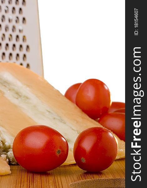 Gloucester cheese with Cheese blue slice on a wood desk with tomato. Gloucester cheese with Cheese blue slice on a wood desk with tomato.