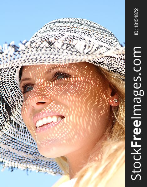 Beautiful blond woman enjoying the summer wearing a sun hat. Beautiful blond woman enjoying the summer wearing a sun hat