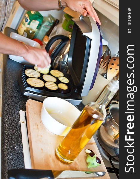 Man Grilling Aubergines