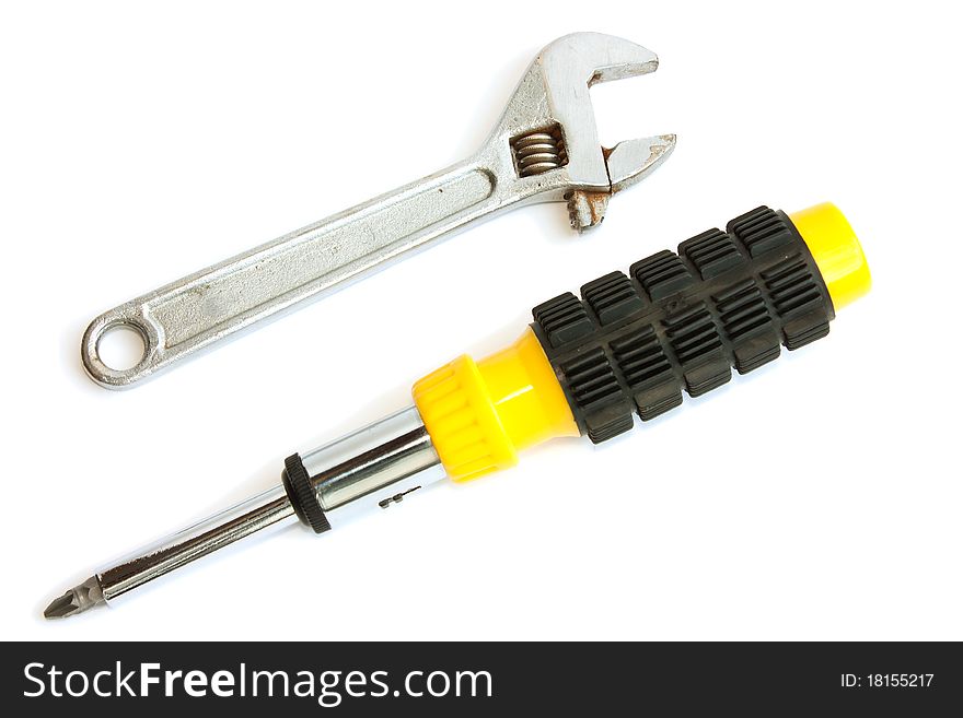 Screwdriver and a wrench on a white background
