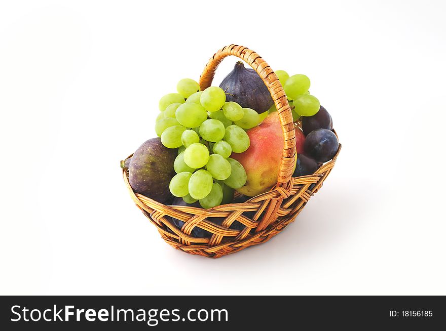 Fresh fruits in the basket isolated on white background
