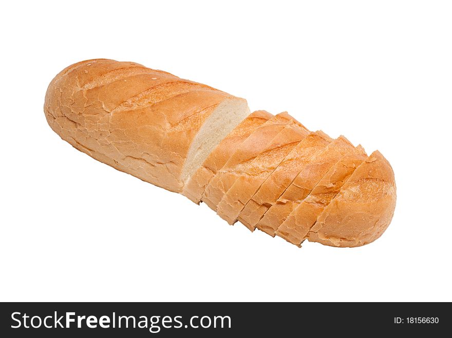 The white bread long loaf is cut on pieces. On a white background