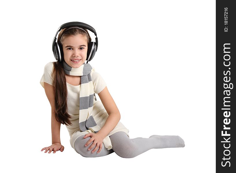 Cute little girl listening to the music. Studio