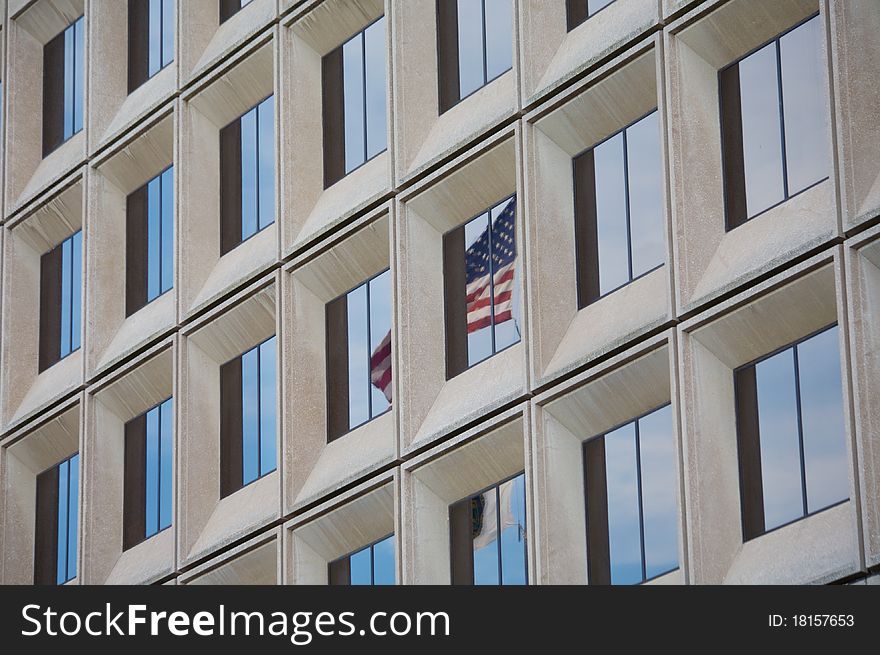 American Flag Reflected In Business Building
