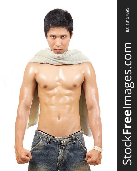 Young man with towel on his neck showing his body muscle. Young man with towel on his neck showing his body muscle