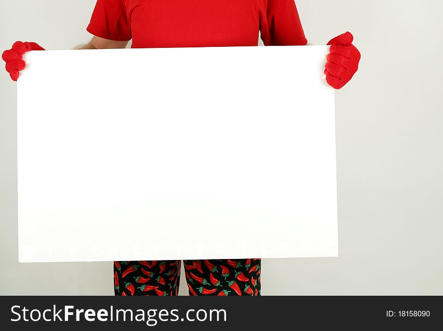 Blank white sign held by an adult seen below shoulders who is wearing red t-shirt, gloves, and cayenne pepper print pants. Blank white sign held by an adult seen below shoulders who is wearing red t-shirt, gloves, and cayenne pepper print pants.