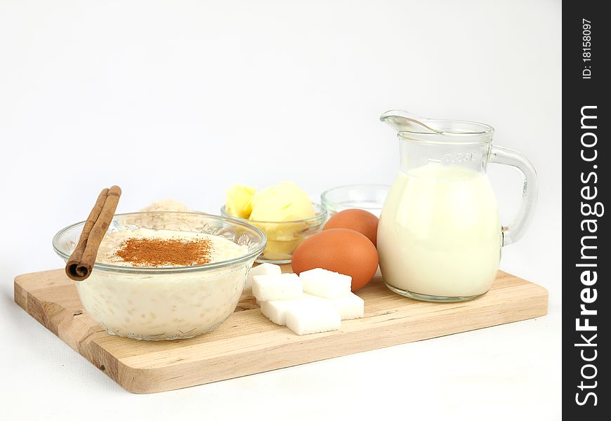 Creamy rice pudding on  bowl with cinnamon and all the ingredients. Creamy rice pudding on  bowl with cinnamon and all the ingredients